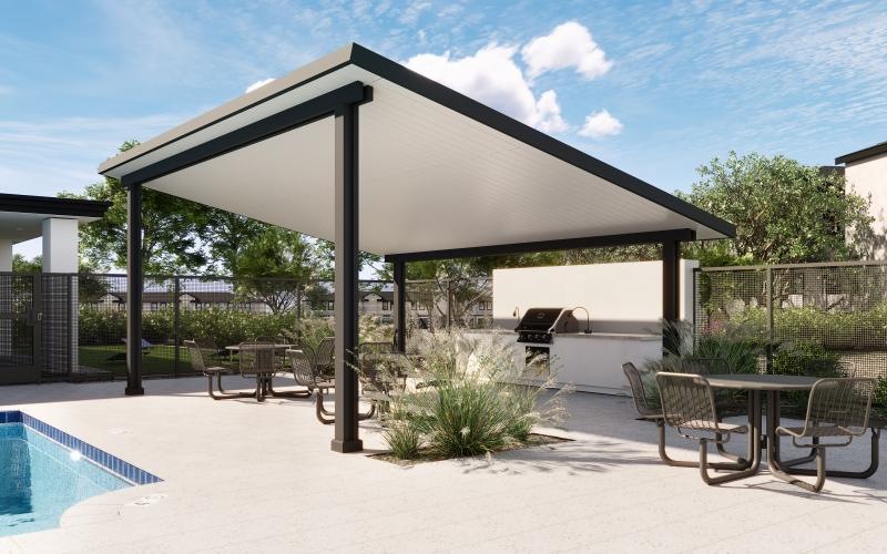 a covered patio with a table and chairs and a pool