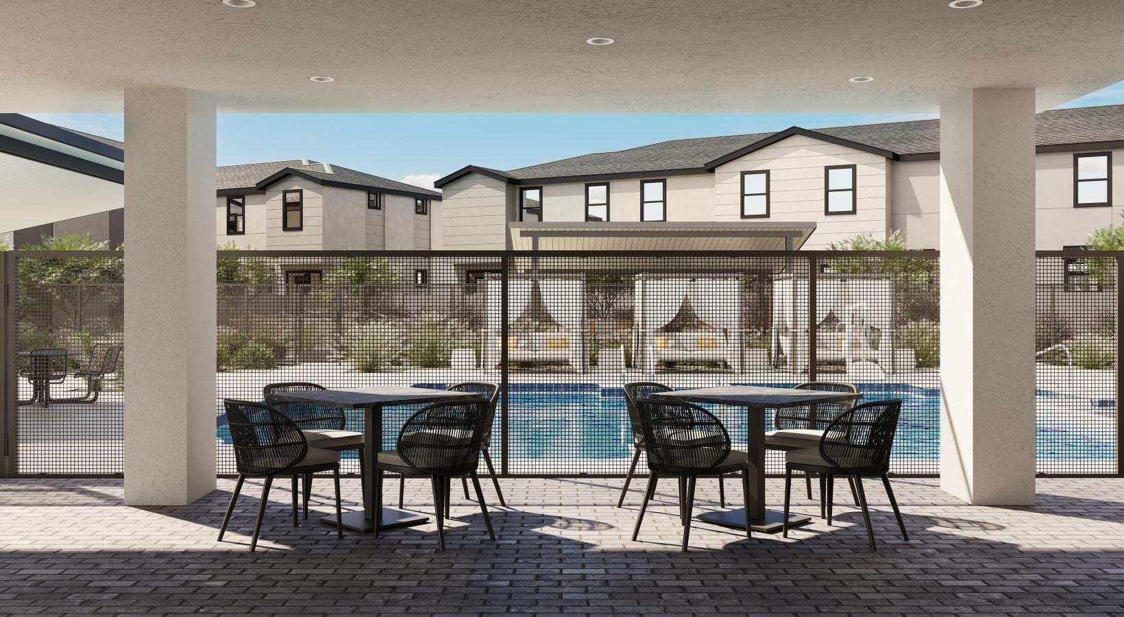 a patio with a table and chairs