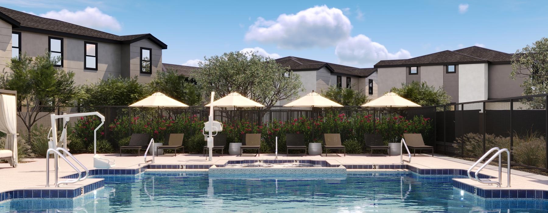 a swimming pool with chairs and umbrellas by a building