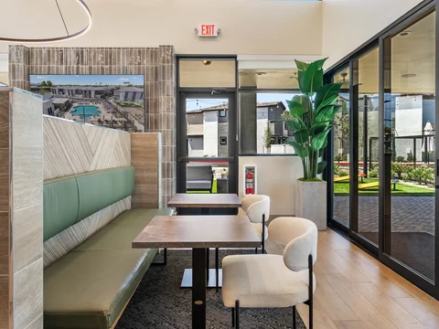 Upholstered booth and lounge chairs beside the clubhouse windows