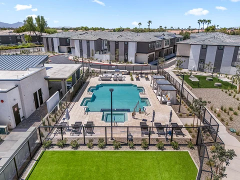 Elevated view of the pool, clubhouse, and surrounding townhomes