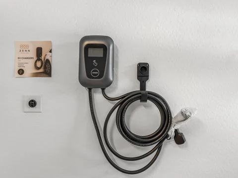 Wall-mounted EV charger and charging cable inside a garage
