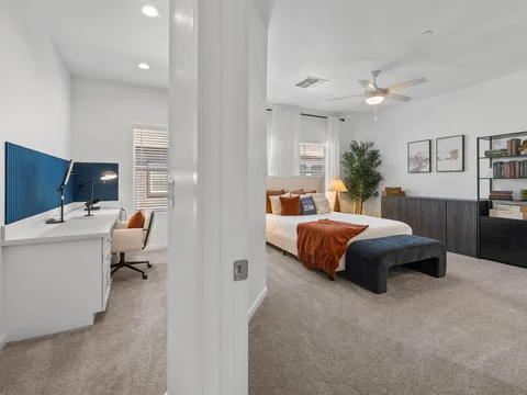 Upstairs hallway connecting a home office and a furnished bedroom