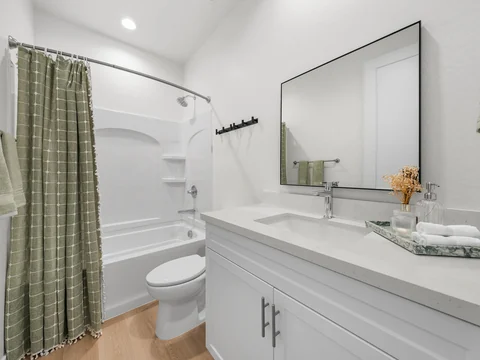 Bathroom with a white vanity and a shower-tub combination