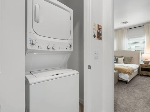 Stacked washer and dryer in an upstairs laundry closet