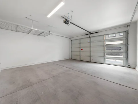 Open two-car garage with a ceiling-mounted storage rack